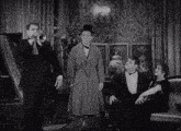 a man playing a trumpet is surrounded by other men