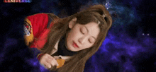 a woman is laying on her back with her eyes closed in front of a galaxy background .