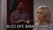 a man is holding a bible in front of a woman and saying `` buzz off , bambojan '' .