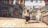 a man is riding a bike down a street with flags hanging from the buildings