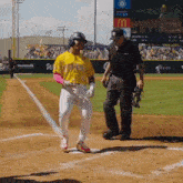 a baseball player wearing a yellow jersey that says tigers on it