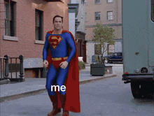 a man in a superman costume is walking down a street with the word me on the sidewalk