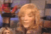 a blurry picture of a woman 's face with blonde hair .