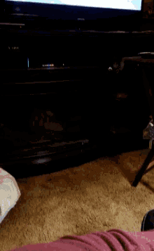 a person is sitting in front of a tv with a balloon on it
