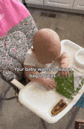 a baby is sitting in a high chair with a bag of peas on it
