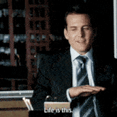 a man in a suit says life is this