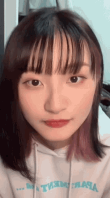 a close up of a girl 's face wearing a hoodie