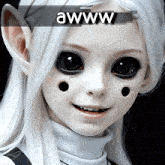 a close up of a doll with black eyes and the words awww above it