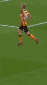 a soccer player with the number 20 on his jersey is walking on the field