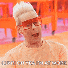 a man wearing sunglasses and an orange shirt says " cum "