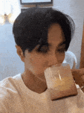 a close up of a person drinking from a cup