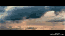 a picture of a cloudy sky with the website makeagif.com visible