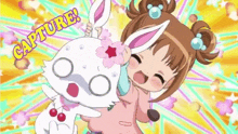 a little girl is holding a white rabbit with the words capture written on the bottom