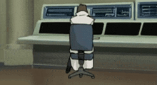 a man is sitting in a chair in front of a computer monitor
