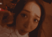 a blurry picture of a woman with the number 01 on the bottom left