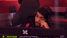 a man wearing headphones with the words tech pause below him