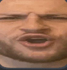 a close up of a man 's face with his mouth open and eyes closed .