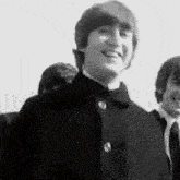 a black and white photo of john lennon and ringo starr .