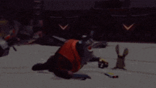 a cartoon character is crawling on the ground while another character watches