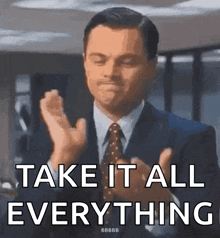 a man in a suit and tie is clapping his hands and says take it all everything .