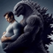 a man is holding a pregnant belly next to a giant monster .