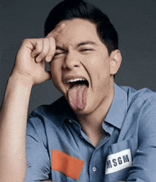 a man wearing a msgm shirt is sticking his tongue out ..