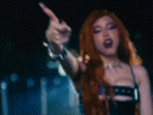 a blurry picture of a woman with red hair and a black dress .