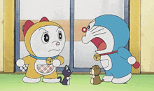 a cartoon character named doraemon is standing next to a cat and a dog