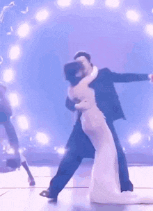 a man and a woman are dancing on a stage in front of a crowd .