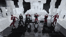 a group of young men are dancing on a stage and one of them is wearing a shirt that says ' i love you '