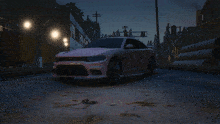a dodge charger is driving down a road at night