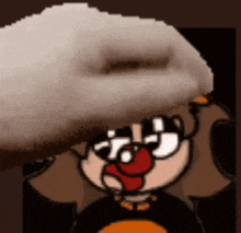 a cartoon character with glasses and a red nose is holding a white object in his hand .