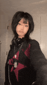 the girl is wearing headphones and a necklace with a cross on it .