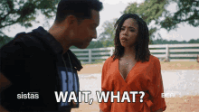 a man and a woman are standing next to each other and the woman is asking the man to wait what