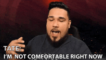a man with a beard is saying tate i 'm not comfortable right now