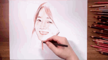 a person is drawing a picture of a woman 's face