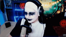 a woman in a nun costume is talking into a microphone with headphones on