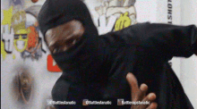 a man wearing a black hooded jacket with the words battlesfanatic on the bottom right