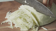 chopping cabbage two plaid aprons slice the cabbage thinly sliced cabbage