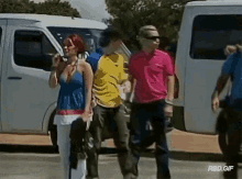 a group of people walking in front of a white van with rbd.gif written on the bottom right