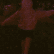 the back of a person wearing a purple hoodie with a hood .