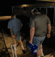 a man is carrying a box that says bud light on it