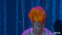 a drag queen is wearing a purple dress and says oh shit .