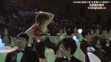 a woman in a bra is dancing in front of a crowd at a 2011 mbc awards