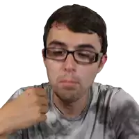 a man wearing glasses and a tie dye shirt has his fist in the air