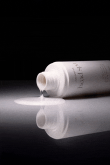 a bottle of headspray is pouring out of the top