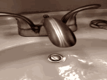 a close up of a bathroom sink with a faucet