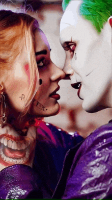 the joker and harley quinn are looking into each other 's eyes ..
