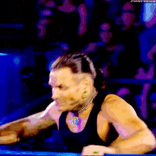 a man in a black tank top is screaming in front of a crowd with the hashtag #thenextbigthing