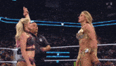 a woman in a wrestling ring with a w logo on the bottom right
